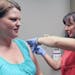 Nurse Helena Gustafson gave Stephanie Pelach a seasonal flu shot at the Fairview clinic in New Brighton. Pregnant women such as Pelach are being urged