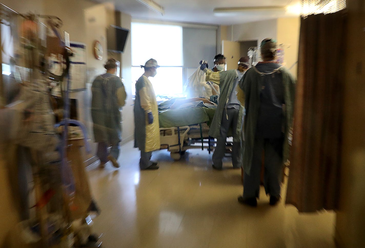 Healthcare workers get a COVID-19 patient situated after proning the patient, which helps blood flow and breathing, in the third floor ICU at Bethesda Hospital.