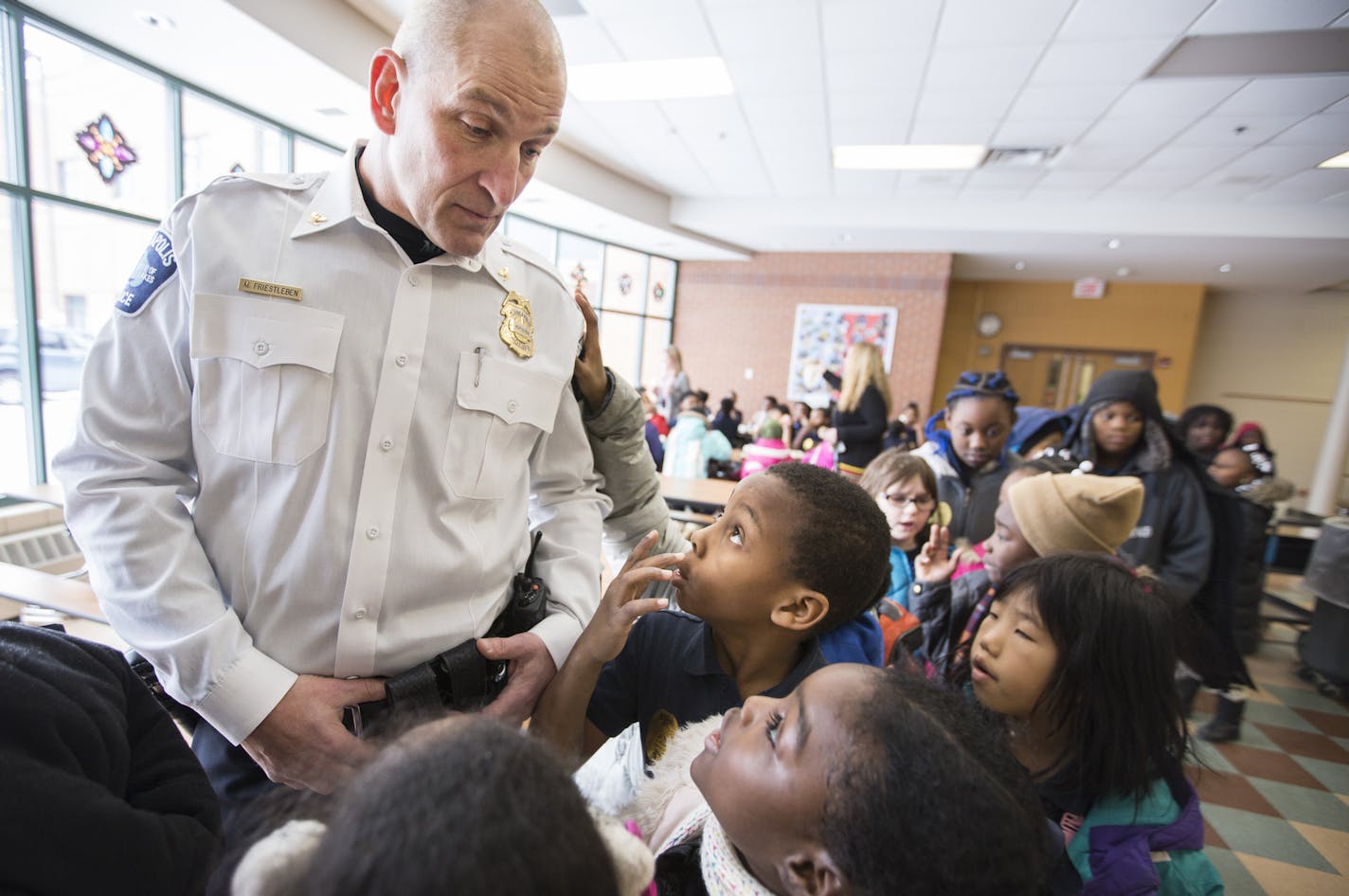 Inspector Mike Friestleben of the Minneapolis Police Department's Fourth Precinct lines up with third graders during lunch at Lucy Craft Laney Community School in Minneapolis for lunch on Thursday, February 4, 2016. ] (Leila Navidi/Star Tribune) leila.navidi@startribune.com