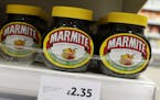 Jars of savoury spread 'Marmite' which is owned by the Anglo-Dutch multinational Unilever, on sale in a branch of Tesco in central London, Thursday, O