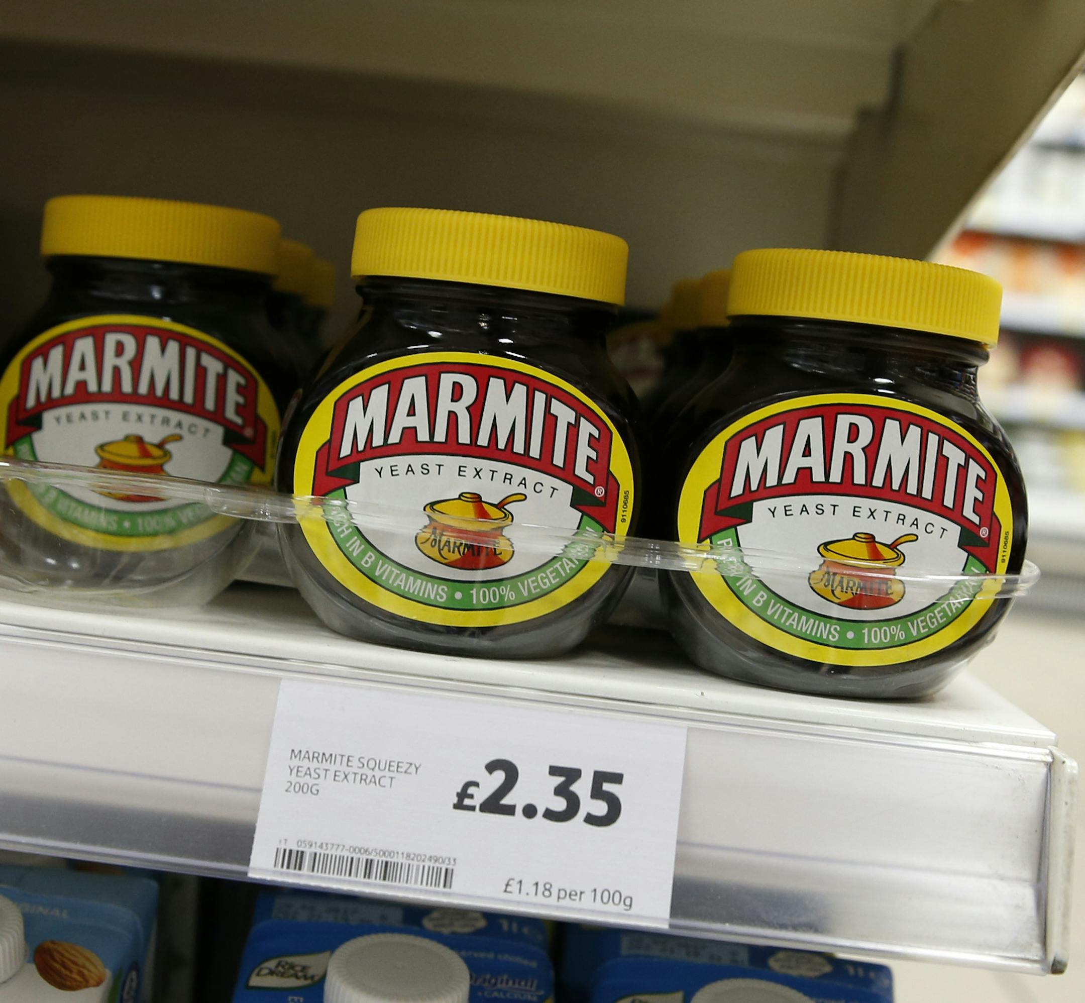 Jars of savoury spread 'Marmite' which is owned by the Anglo-Dutch multinational Unilever, on sale in a branch of Tesco in central London, Thursday, Oct. 13,2016. Britain's biggest supermarket chain, Tesco, has pulled cherished products such as Marmite spread and Ben & Jerry's ice cream from its website amid a dispute with consumer goods giant Unilever. (AP Photo/Alastair Grant)