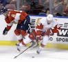 Florida Panthers defenseman Jason Demers (55) battles Detroit Red Wings left wing Thomas Vanek (62) for control of the puck during the first period of