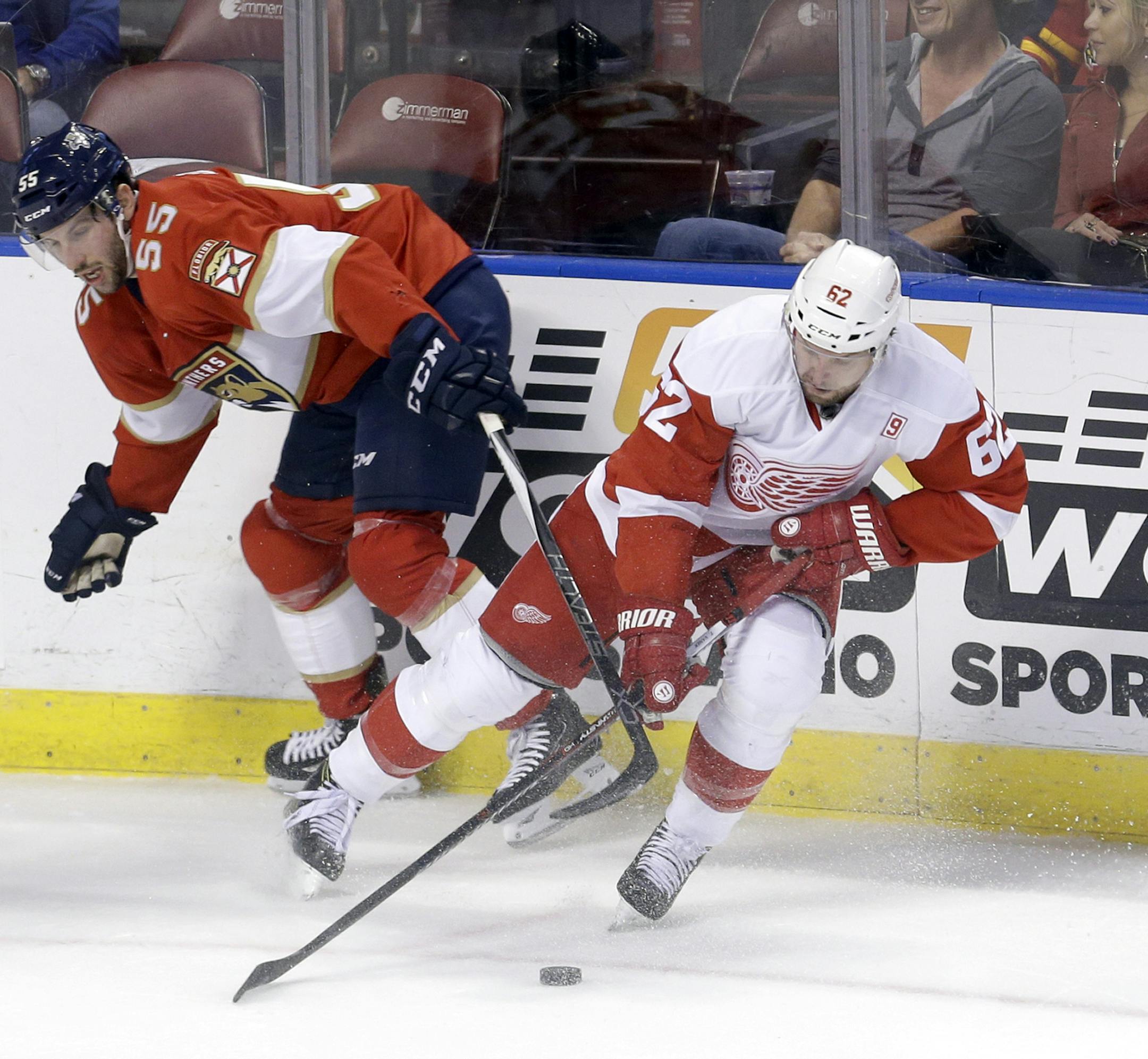 Florida Panthers defenseman Jason Demers (55) battles Detroit Red Wings left wing Thomas Vanek (62) for control of the puck during the first period of an NHL hockey game, Saturday, Oct. 15, 2016, in Sunrise, Fla. (AP Photo/Alan Diaz)