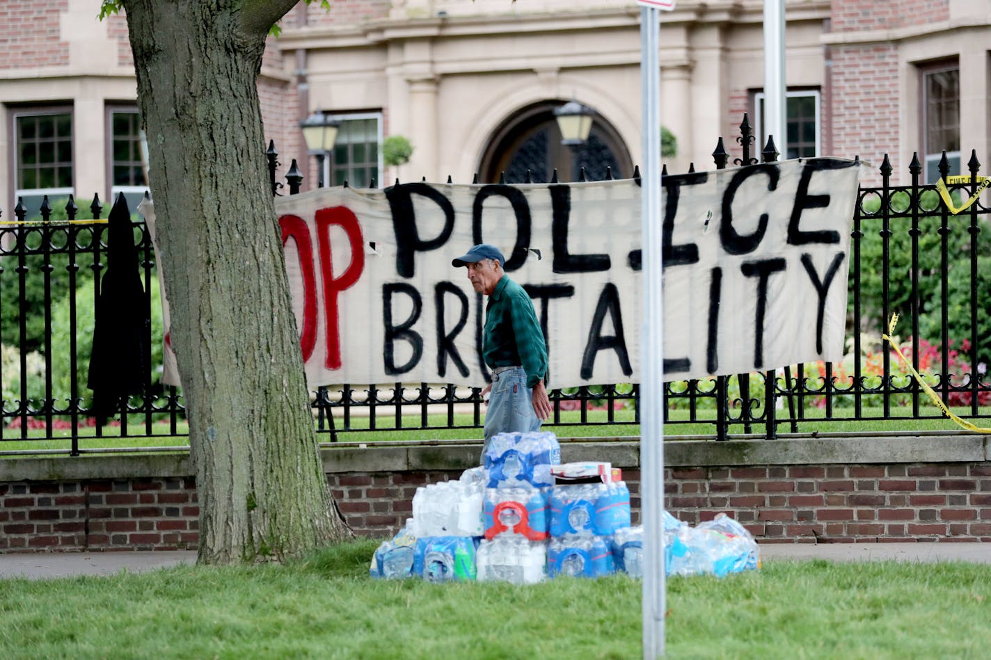 Jahan Zabmeram of St. Paul turns to look at protestors gathered outside Gov. Mark Dayton's mansion Thursday, July 7, 2016, in response to the shooting of Philando Castile, 32, a St. Paul schools employee, by a police officer following a traffic stop in Falcon Heights, MN. Castile later died Wednesday night at HCMC.] (DAVID JOLES/STARTRIBUNE)djoles@startribune Protesters at Governor's mansion after police involved shooting in Falcon Heights.**Philando Castile, Jahan Zabmeram, cq (editor's note: t