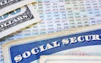 Social Security cards with cash and benefit amount numbers