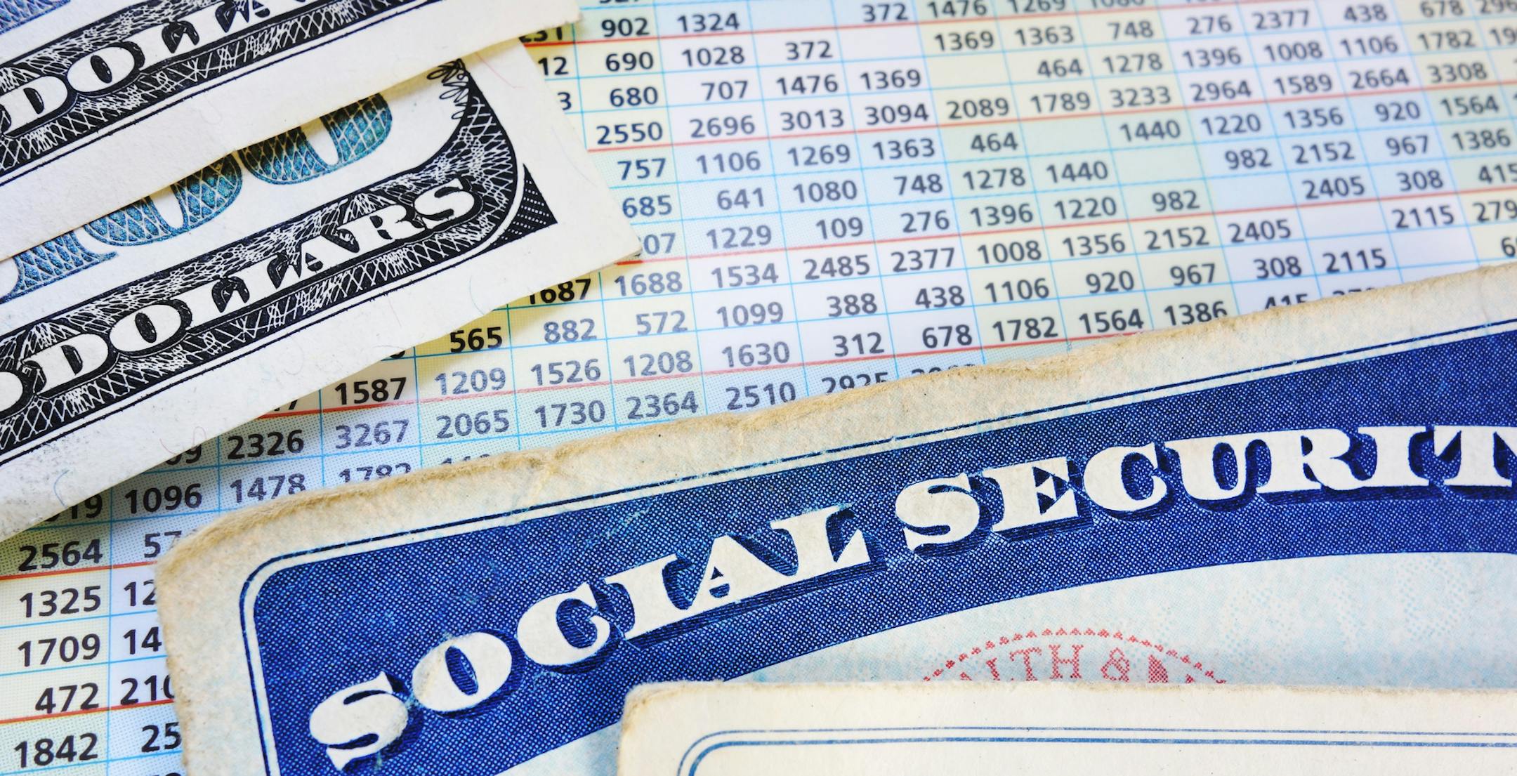 Social Security cards with cash and benefit amount numbers