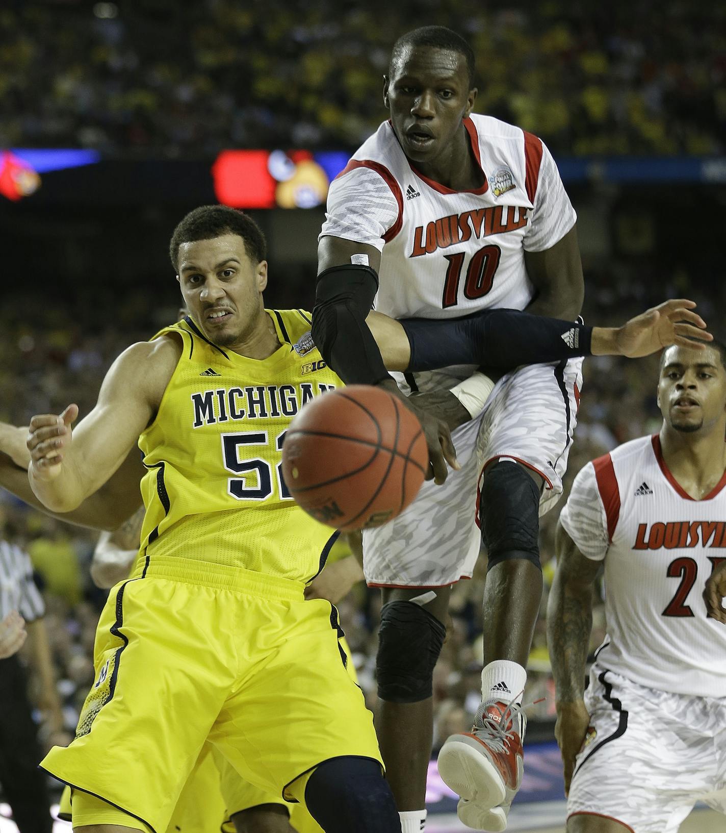 Louisville center Gorgui Dieng (10) and Michigan forward Jordan Morgan (52) vie for a loose ball during the second half of the NCAA Final Four tournament college basketball championship game Monday, April 8, 2013, in Atlanta. (AP Photo/John Bazemore) ORG XMIT: FF244