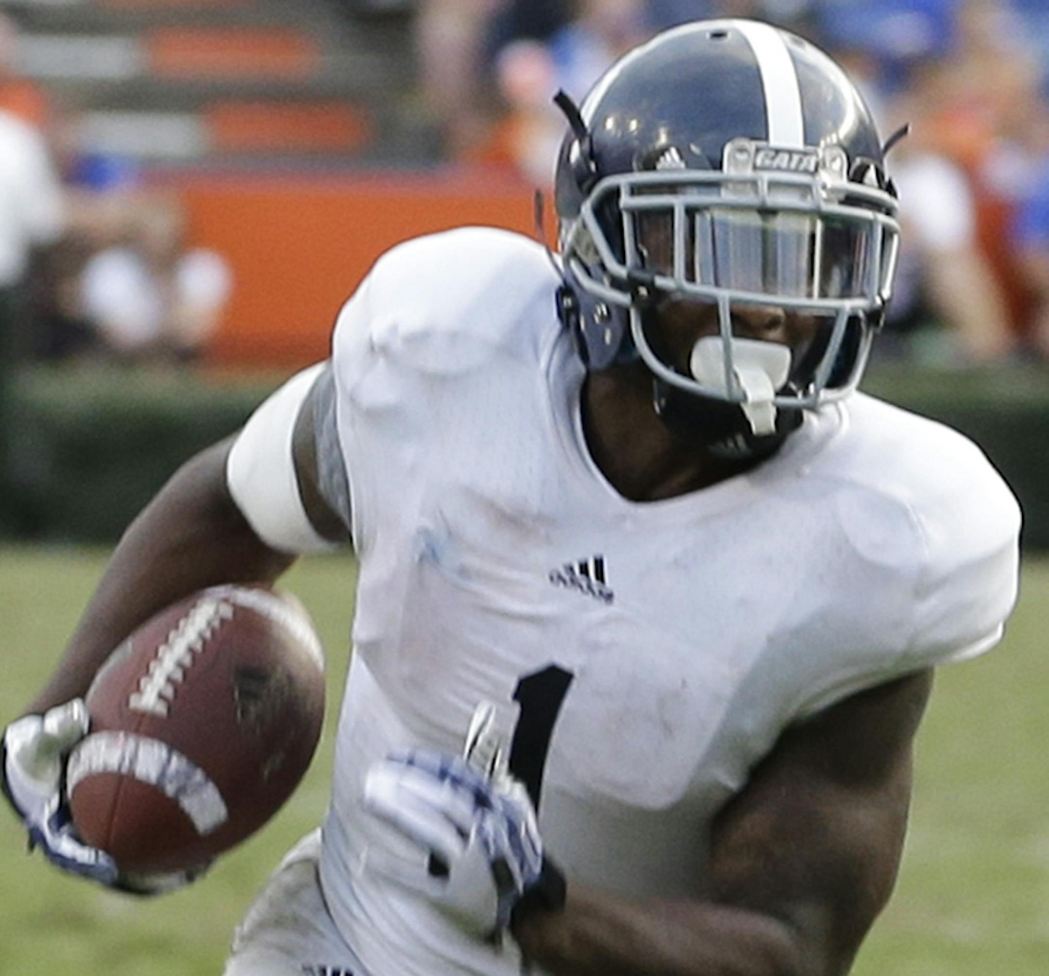 Georgia Southern's Jerick McKinnon (1) runs past Florida linebacker Ronald Powell (7) for a 14-yard touchdown during the second half of an NCAA college football game in Gainesville, Fla., Saturday, Nov. 23, 2013. Georgia Southern won the game 26-20.(AP Photo/John Raoux) ORG XMIT: NYOTK