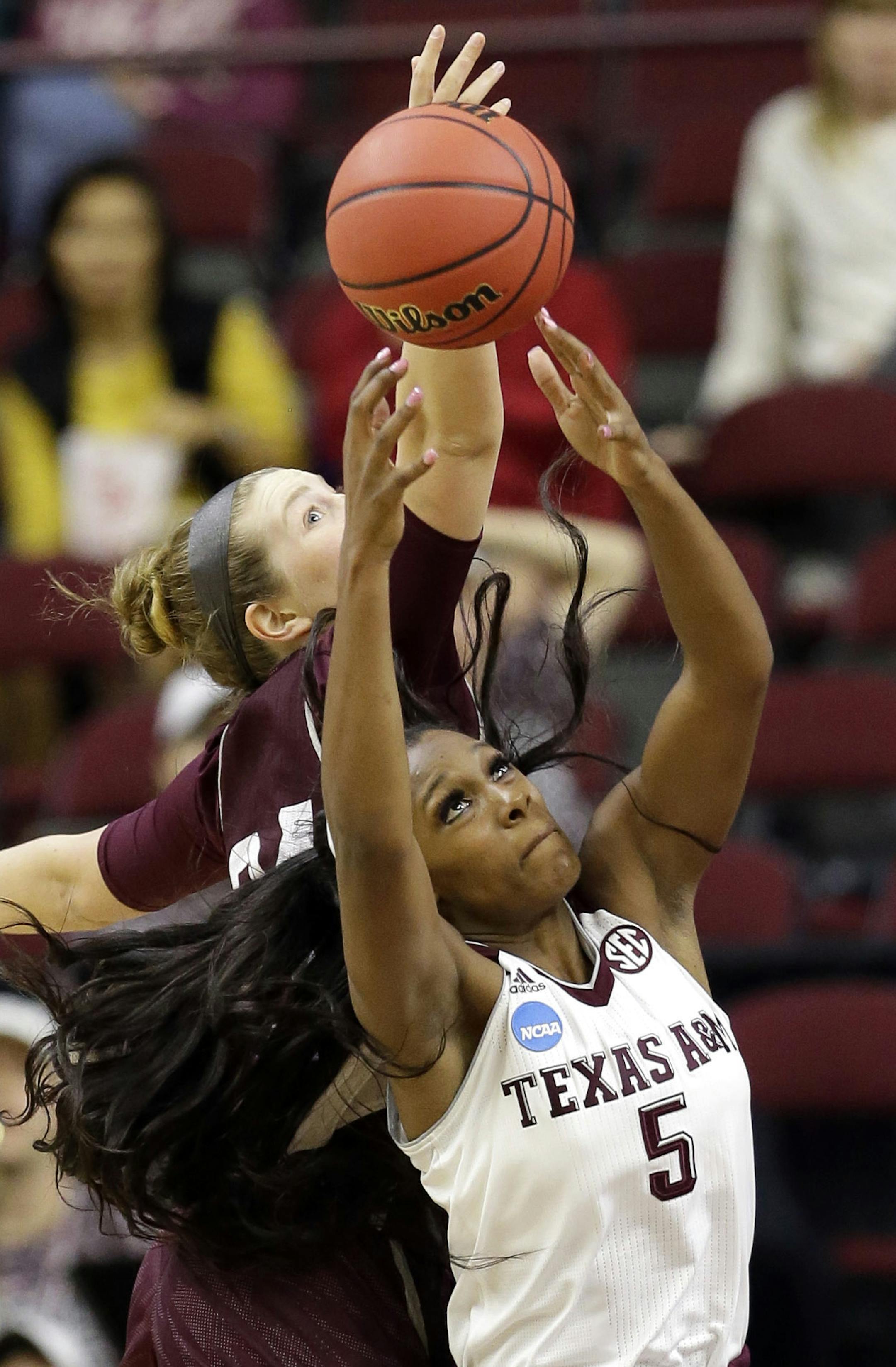 Texas A&M's Anriel Howard (5) pulls down a rebound in front of Missouri State's Rachel Swartz during the second half of a first-round women's college basketball game in the NCAA Tournament Saturday, March 19, 2016, in College Station, Texas. Texas A&M won 74-65.(AP Photo/David J. Phillip)