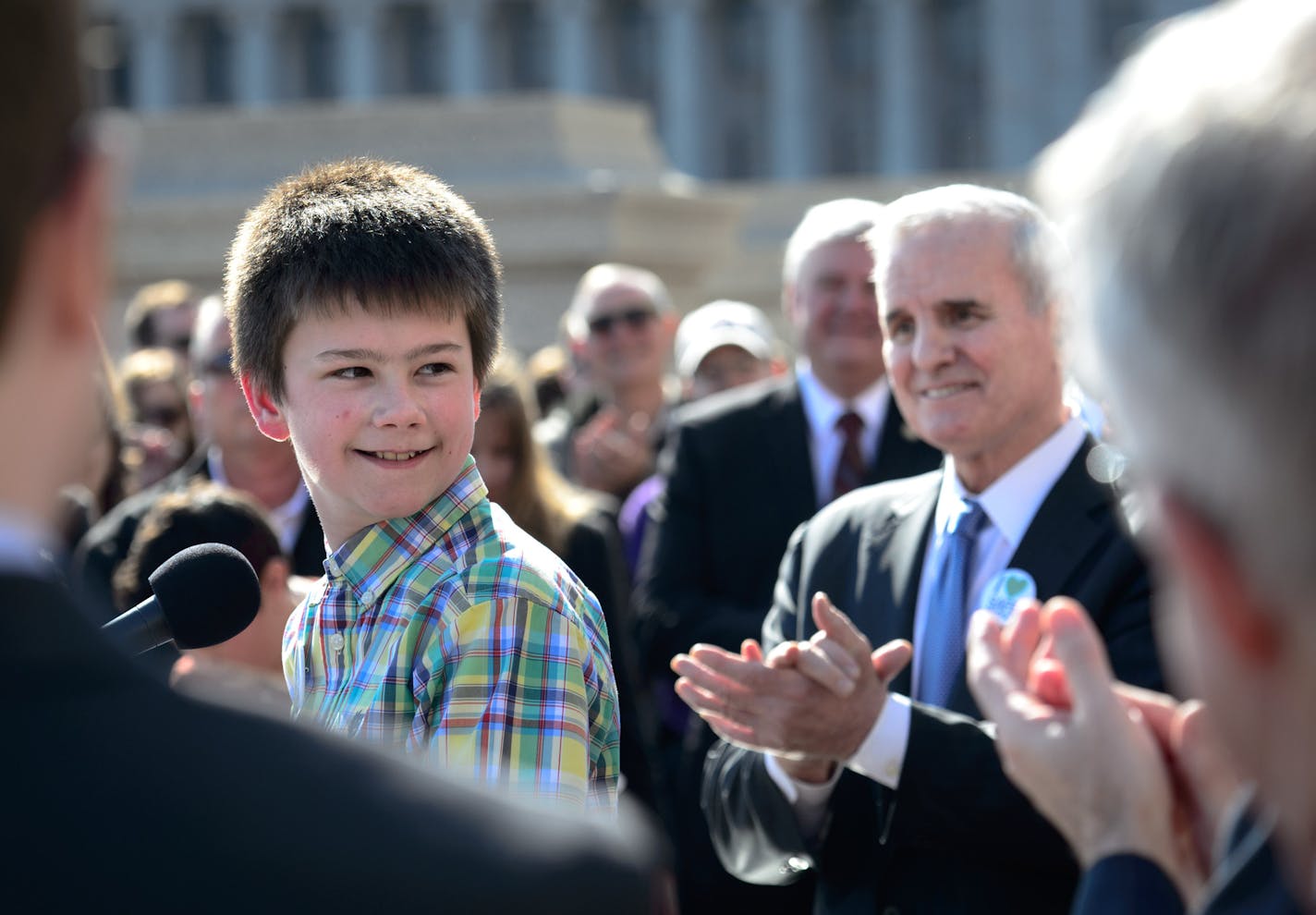 Governor Mark Dayton applauded 11-Year-Old Boy Scout Jake Ross who testified about being bullied looked back to thank bill sponsors State Rep. Jim Davnie and State Sen. Scott Dibble. ] GLEN STUBBE * gstubbe@startribune.com Wednesday, April 9, 2014