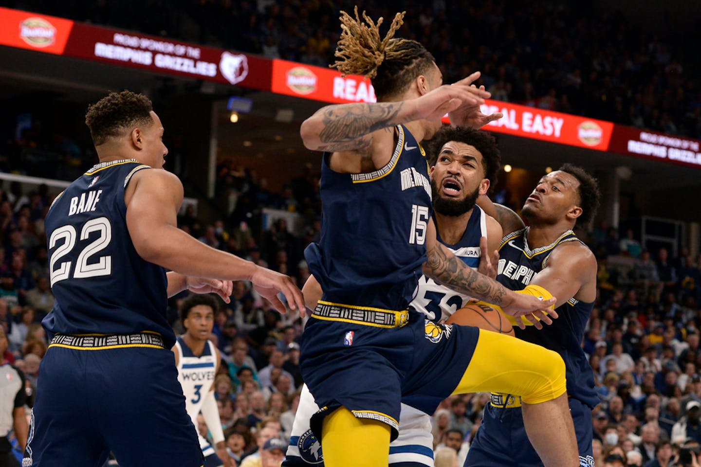 Minnesota Timberwolves center Karl-Anthony Towns (32) struggles for control of the ball against Memphis Grizzlies forward Brandon Clarke on Tuesday.