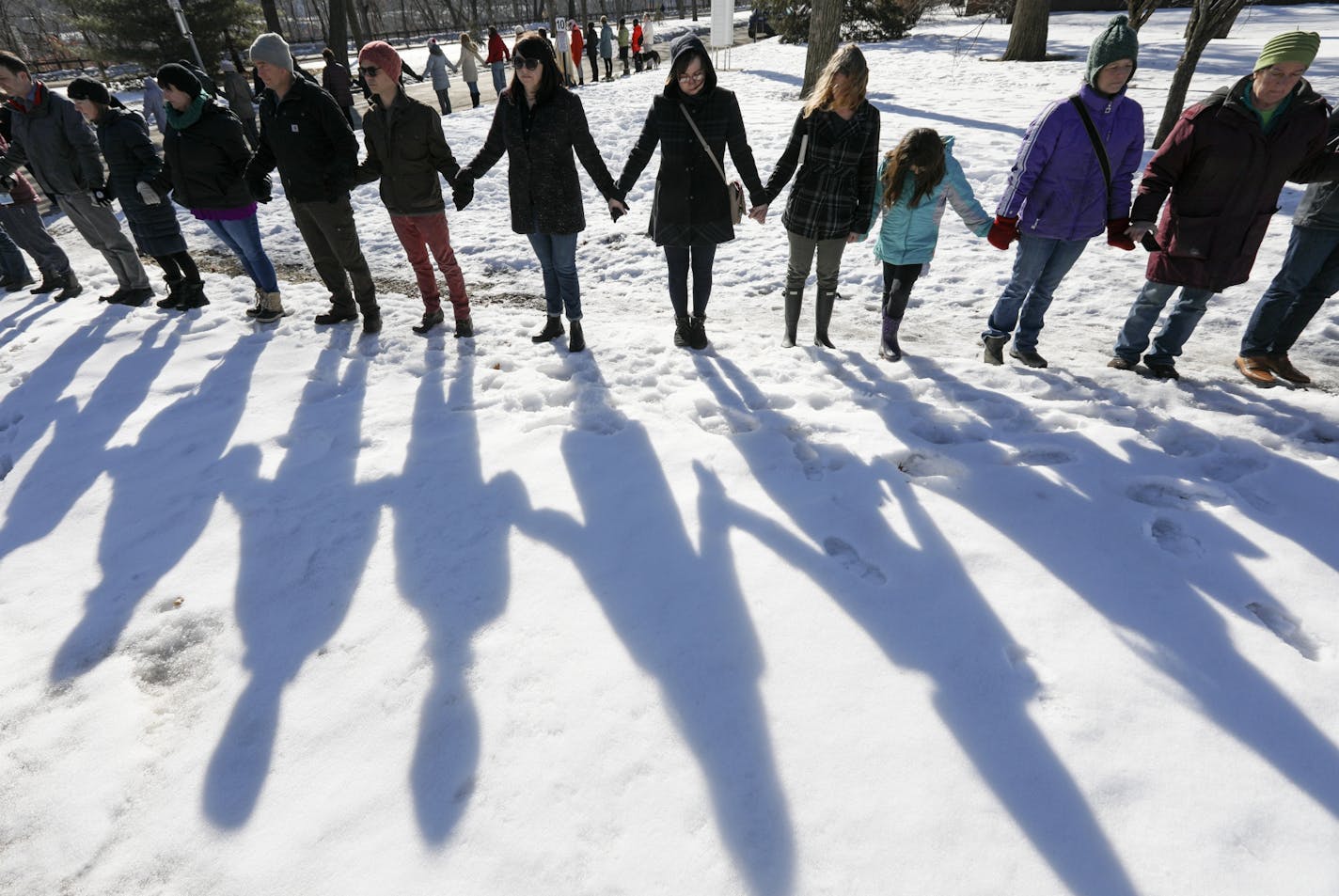 About 50 parents, neighbors and friends of students at Dowling Elementary in Minneapolis, joined hands in silence for 17 minutes outside the school.