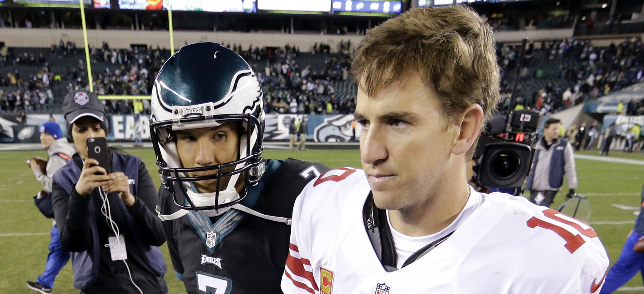 Philadelphia Eagles quarterback Sam Bradford (7) and New York Giants quarterback Eli Manning (10) walk on the field after an NFL football game, Monday, Oct. 19, 2015, in Philadelphia. The Eagles won 27-7. (AP Photo/Matt Rourke)