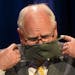 Minnesota Gov. Tim Walz put his face mask at the conclusion of a press conference in July 2020.
