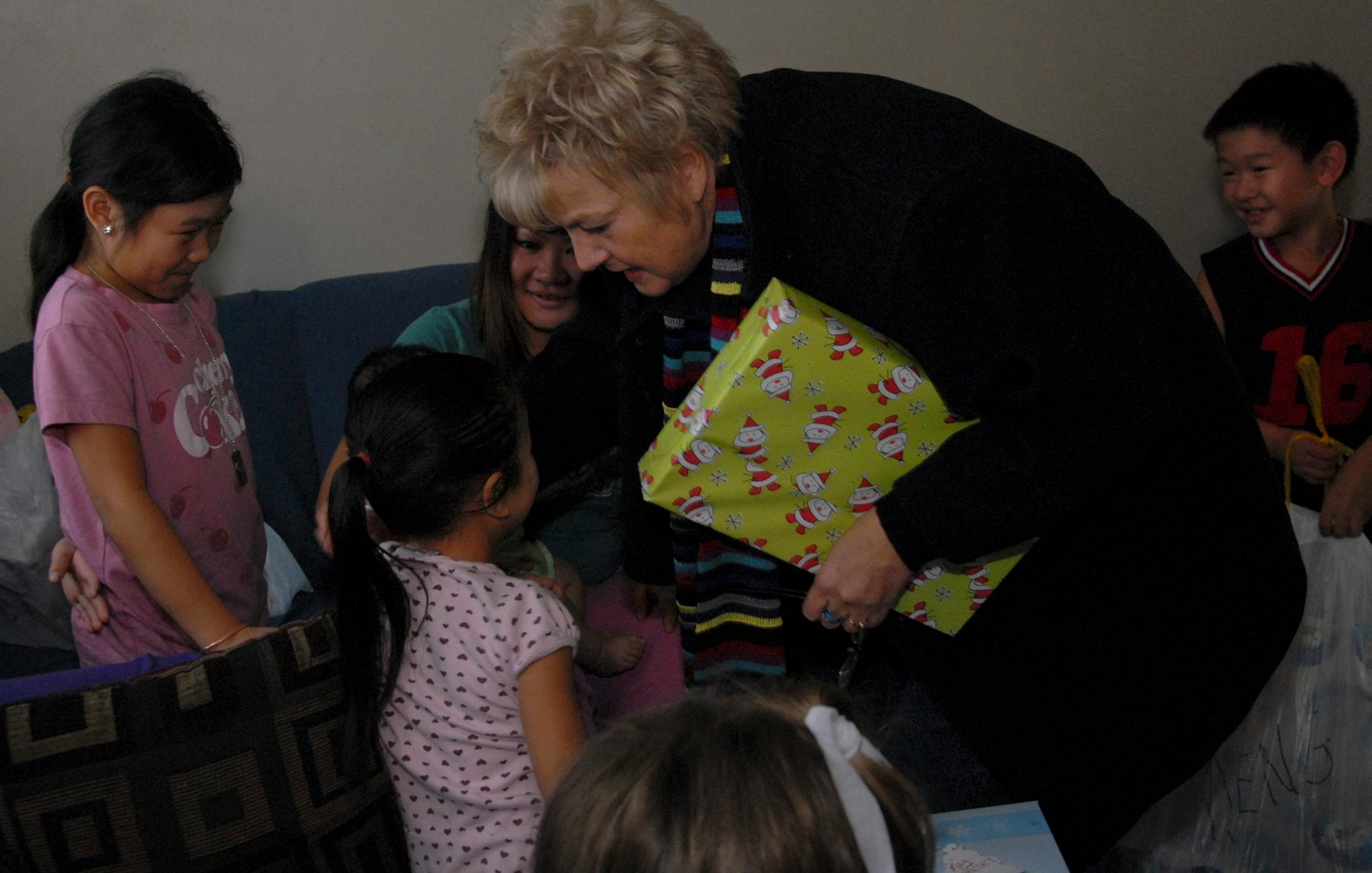 Judi Schulz of Maple Grove exchanged hugs around the room after delivering presents to the Yang family. Schulz and her friends and relatives have bought gifts for the Yangs three years running.