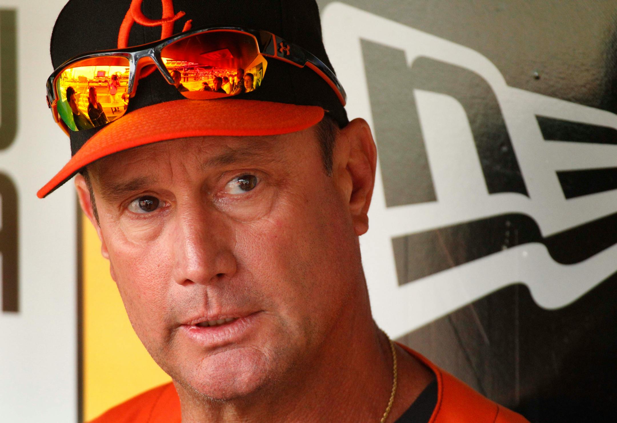 Former Pittsburgh Pirates manager John Russell, now third base coach for the Baltimore Orioles, sits in the dugout before a baseball game between the Orioles and the Pirates in Pittsburgh, Monday, June 20, 2011. (AP Photo/Gene J. Puskar)