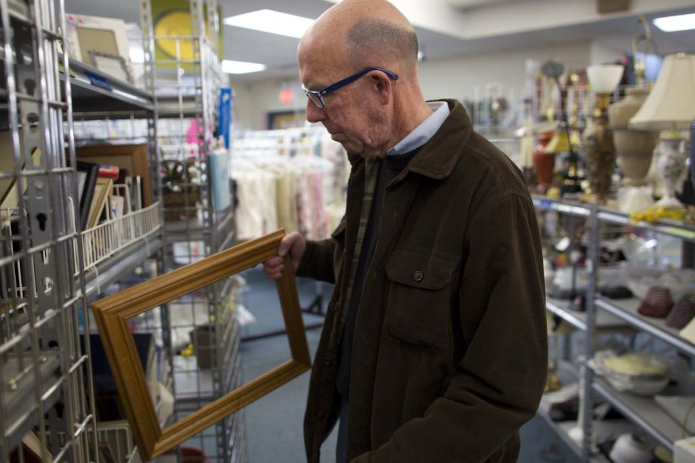 Tom Sparks shopped at Arc's Value Village Thrift Store and Donation Center in Bloomington, Minn. on Friday, February 24, 2012. Sparks, who is also a collector, enjoys shopping at thrift stores to stay on a budget and find unique knick knacks like picture frames.