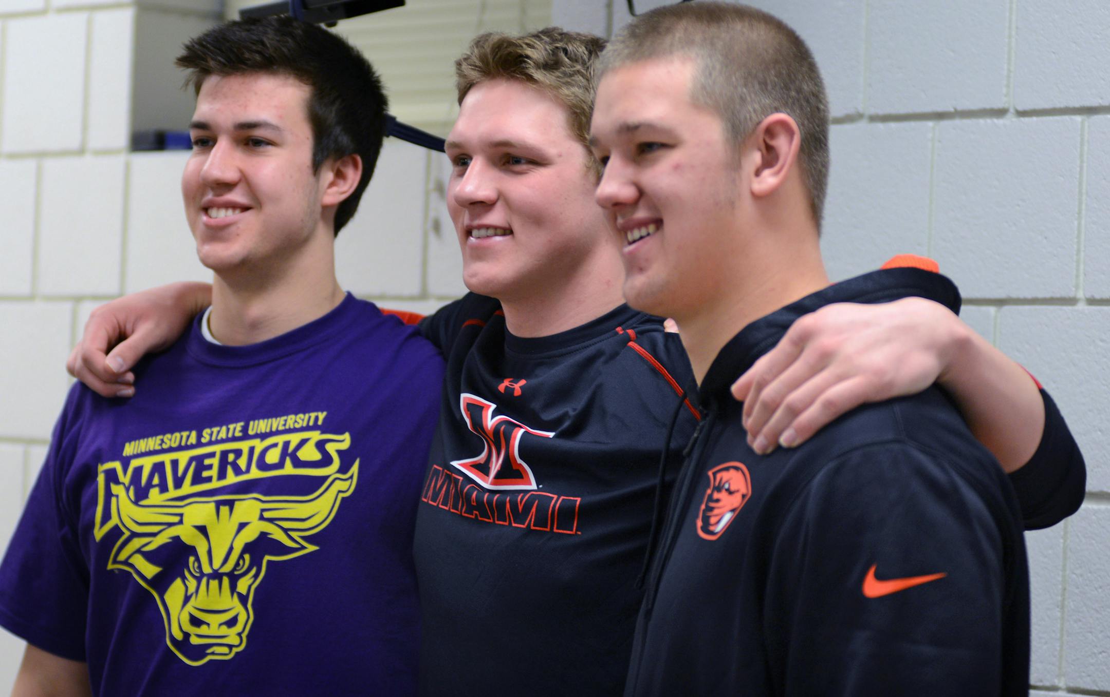 Signing day at Eden Prairie high featured 19 athletes declaring the schools they have chosen. These three friends pose for pictures after the signing event, they are from l to r Richard Cochran who will be playing football for Mankato State, Zach Hovey who be playing football for Miami University, OH and Robert Olson who will be playing football for Oregon State University. signed with. ] Richard.Sennott@startribune.com Richard Sennott/Star Tribune Eden Prairie , Minn. Wednesday 2/5/2014) ** (cq