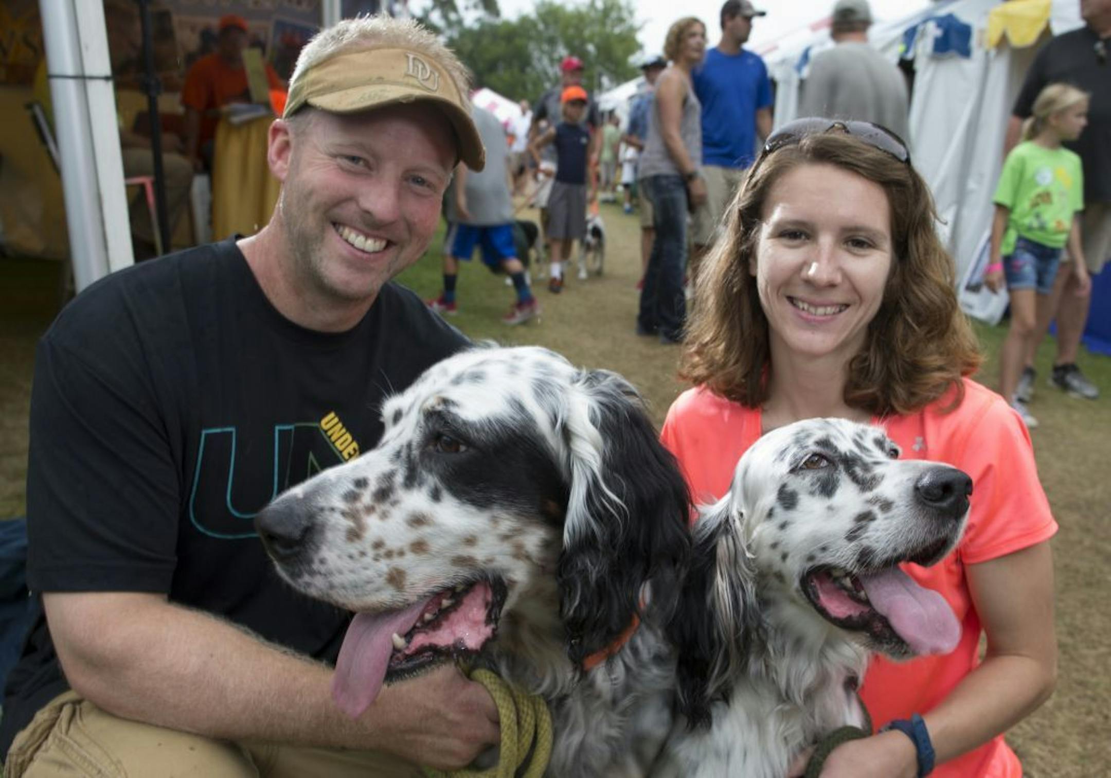 Chad Salonek' and Anna Erdmann, with Doc and Rogue the English Setters   The 2015 Gamefair has developed from one big circus tent to a mini State fair atmosphere over its 34 years. We photographed a slice of the fair through the people that have attending this year, some who have been all 34 years.  [ PHOTO BY TOM WALLACE ' tom.wallace2@comcast.net   owfair081415: Game Fair