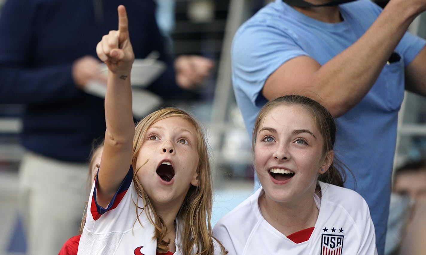 Two young soccer fans cheers as the players enter the field through the tunnel before the match. ] LEILA NAVIDI &#x2022; leila.navidi@startribune.com BACKGROUND INFORMATION: Exhibition soccer match between the USA and Portugal at Allianz Field in St. Paul on Tuesday, September 3, 2019.