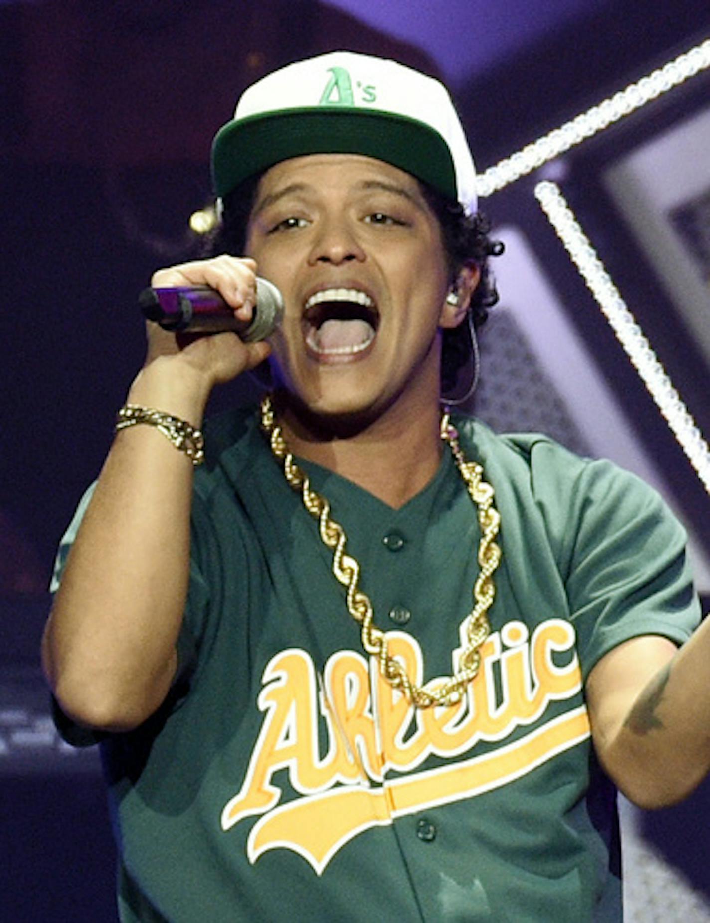 FILE - In this Dec. 2, 2016 file photo, Bruno Mars performs at the 2016 Jingle Ball at Staples Center in Los Angeles. Mars is donating $1 million from his Michigan concert to aid those affected by the Flint water crisis. Mars told the audience Saturday, Aug. 12, 2017, at his show in Auburn Hills that he and tour promoter Live Nation are redirecting funds from the concert to The Community Foundation of Greater Flint, a charity.(Photo by Chris Pizzello/Invision/AP, File)