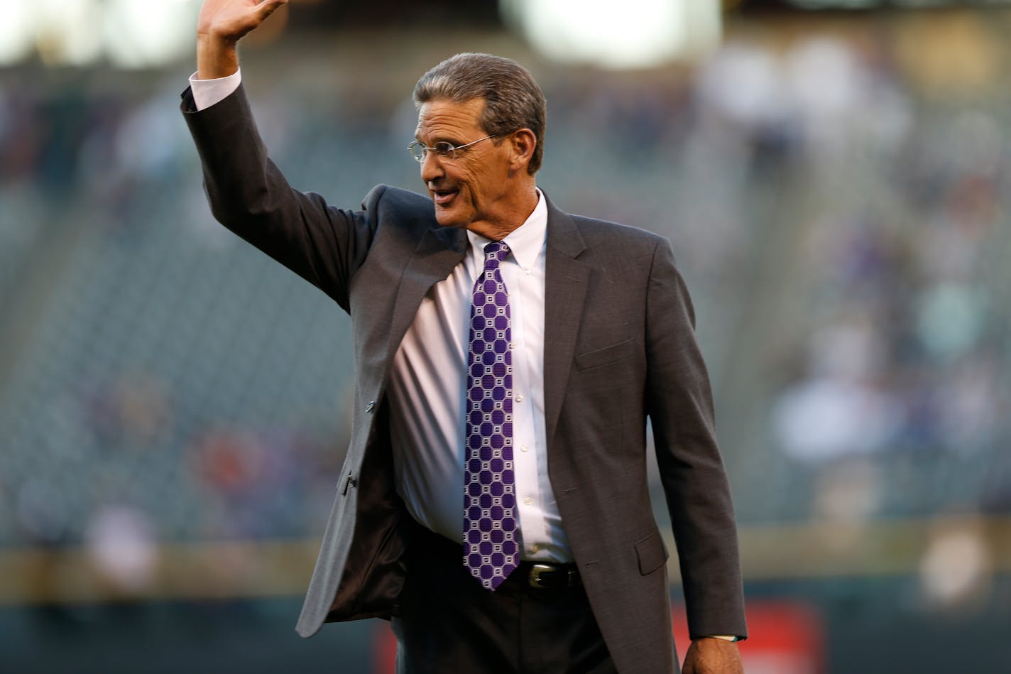 Colorado Rockies television color analyst George Frazier waves to crowd during his retirement ceremony before the Rockies host the Los Angeles Dodgers in the first inning of a baseball game Friday, Sept. 25, 2015, in Denver. (AP Photo/David Zalubowski)