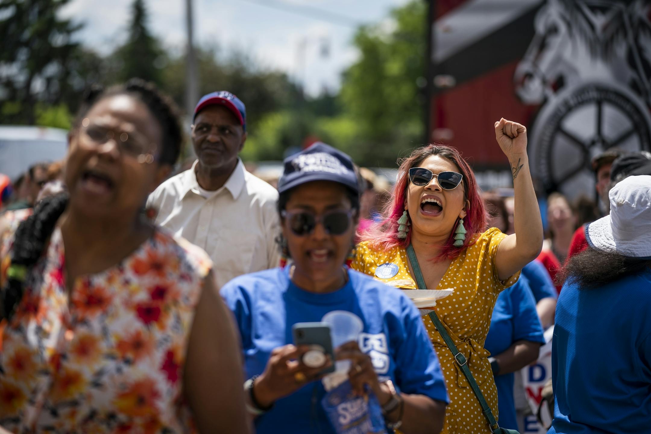 Mari Mansfield, right, a special education assistant at Roosevelt High School, cheered at a rally on June 12, 2019, for higher wages for educational support professionals in the Minneapolis Public Schools.