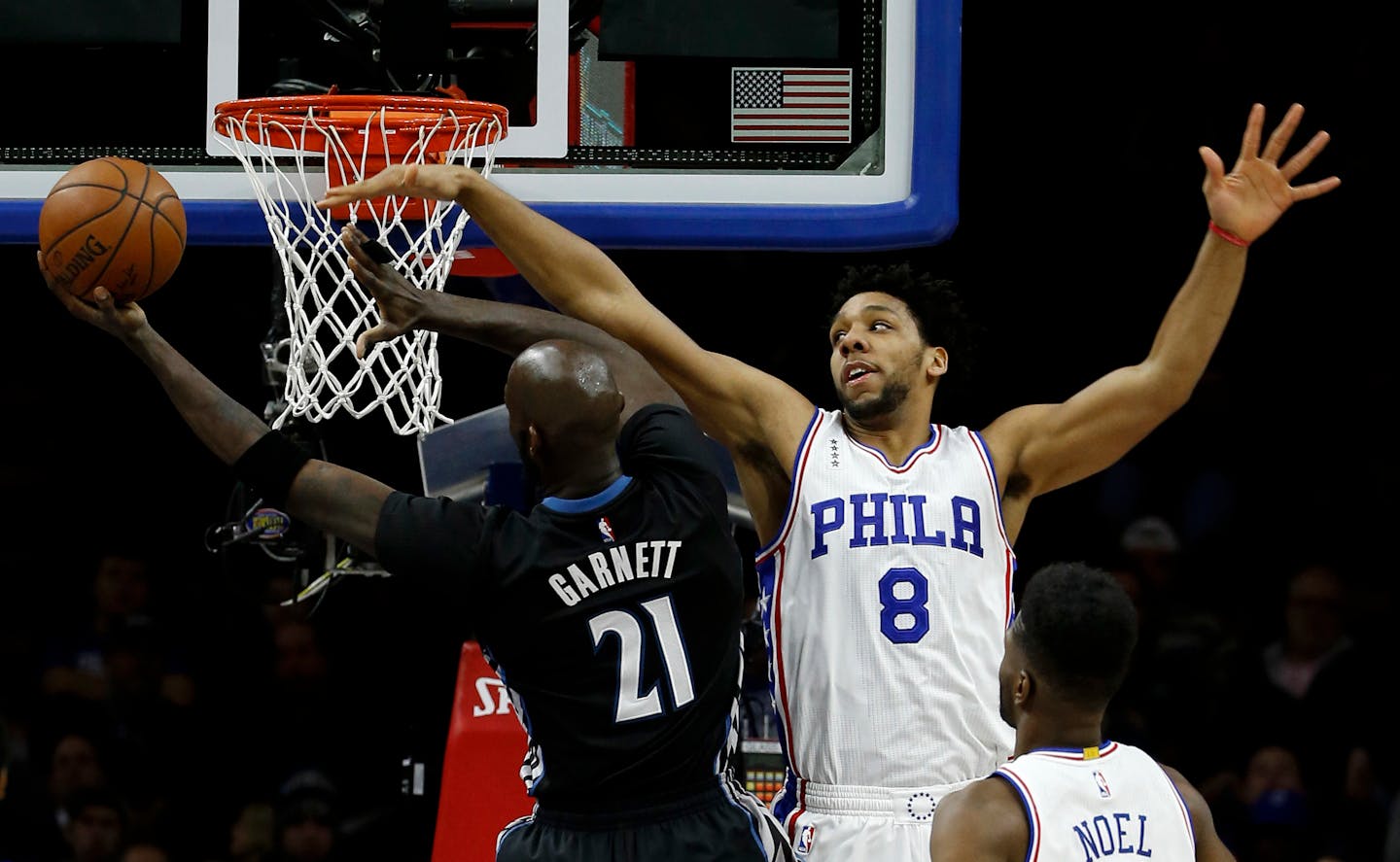 Wolves forward Kevin Garnett went up for a shot against 76ers center Jahlil Okafor during the first half Monday.