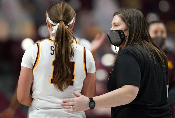 Gophers coach Lindsay Whalen gave a pat on the back to guard Sara Scalia after a loss to the Indiana Hoosiers last month.