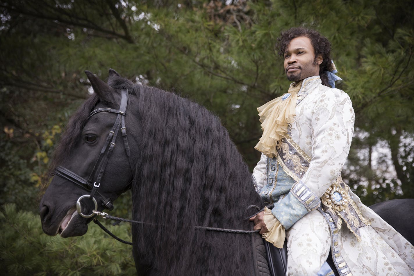 Actor David Murray poses with El Dante, a Friesian stallion, at Carisbrooke Farm in Stillwater.