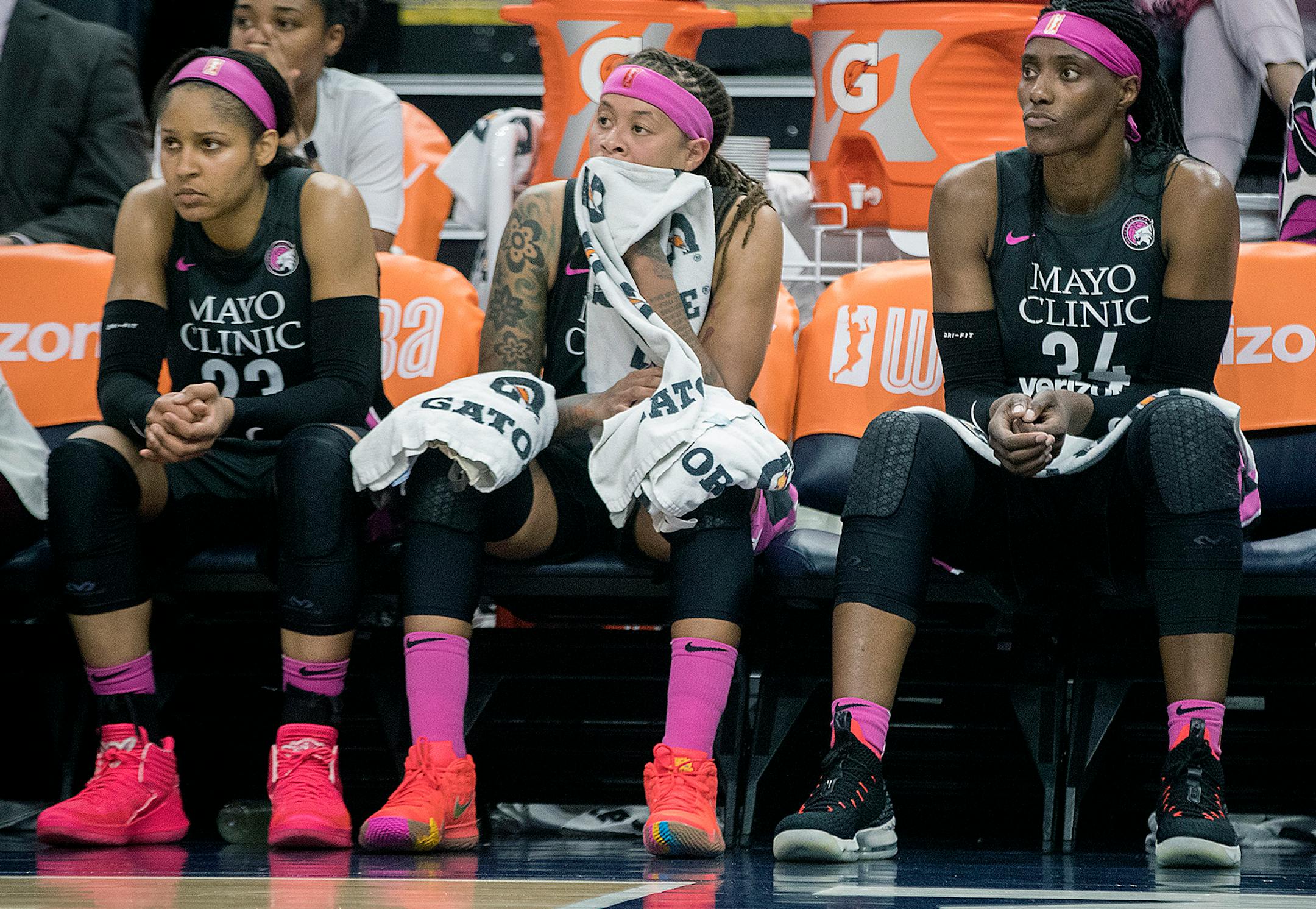 Minnesota Lynx players Maya Moore, Seimone Augustus, and Sylvia Fowles watched their 72-81 loss to the Seattle Storm from the bench late in the game.