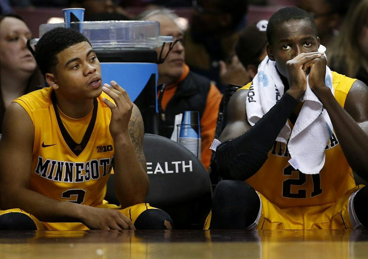 Nate Mason (2) and Bakary Konate (21) watched from the bench in the final second of the game. Milwaukee beat Minnesota by a final score of 74-65.