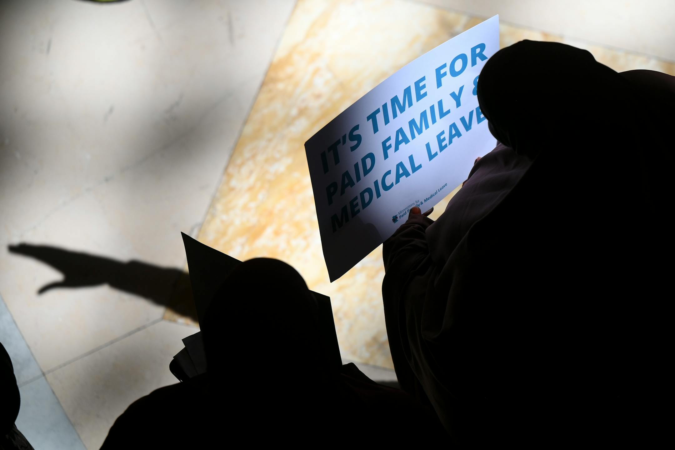 Paid family leave advocates gather for a rally Monday at the Minnesota State Capitol.