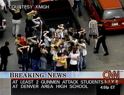 In this image from television, students stand outside Columbine High school Tuesday, April 20, 1999 in Littleton, Colo., after being rescued from inside the school in the wake of a shooting spree.  Two young men dressed in long, black trench coats opened fire in Columbine High school today, scattering students as gunshots ricocheted off lockers, witnesses said.