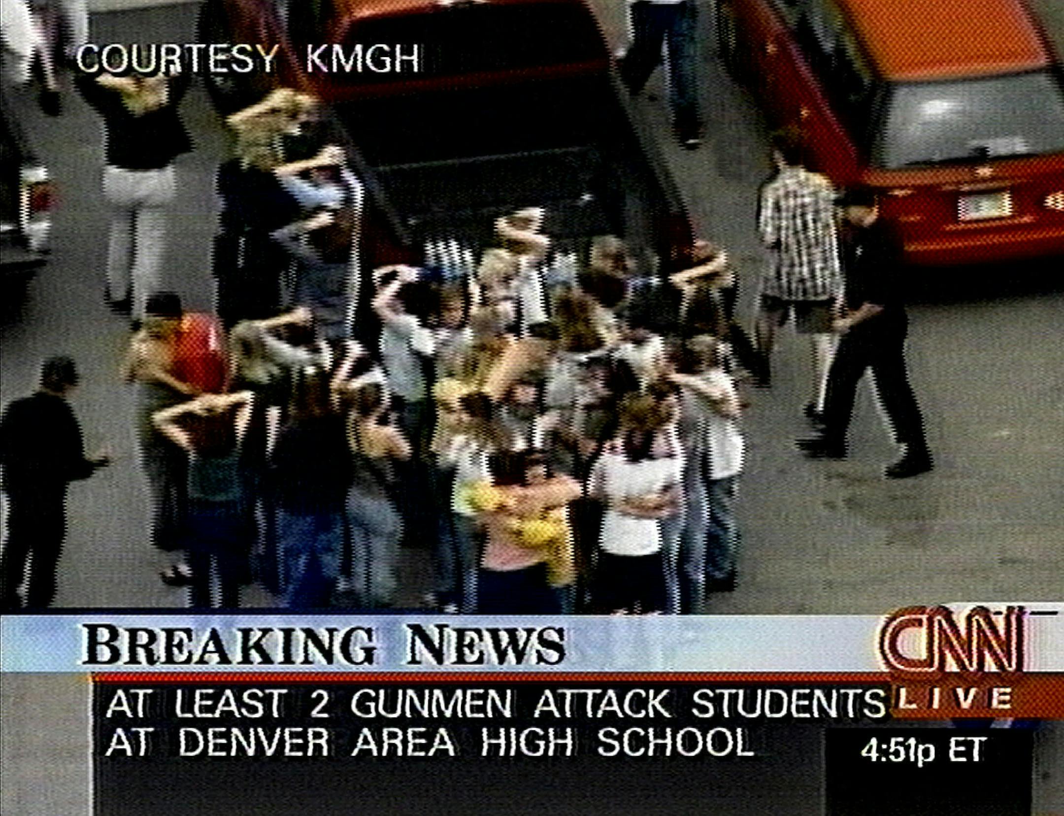 In this image from television, students stand outside Columbine High school Tuesday, April 20, 1999 in Littleton, Colo., after being rescued from inside the school in the wake of a shooting spree.  Two young men dressed in long, black trench coats opened fire in Columbine High school today, scattering students as gunshots ricocheted off lockers, witnesses said.