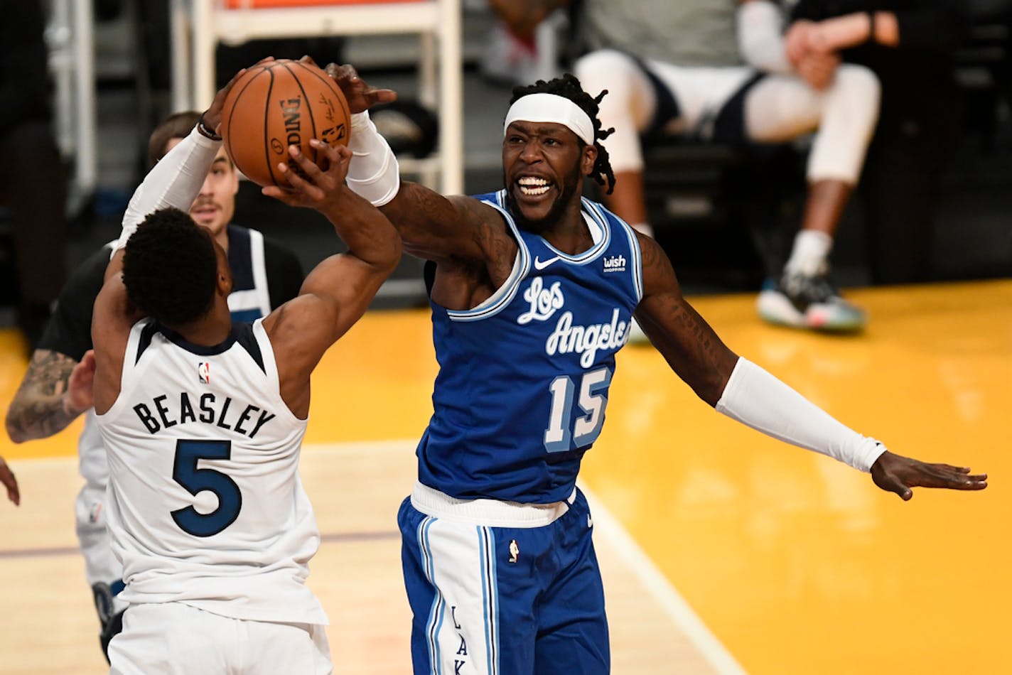 Los Angeles Lakers forward Montrezl Harrell, right, defends Minnesota Timberwolves guard Malik Beasley shooting during the first half of an NBA basketball game in Los Angeles, Sunday, Dec. 27, 2020. (AP Photo/Kyusung Gong)