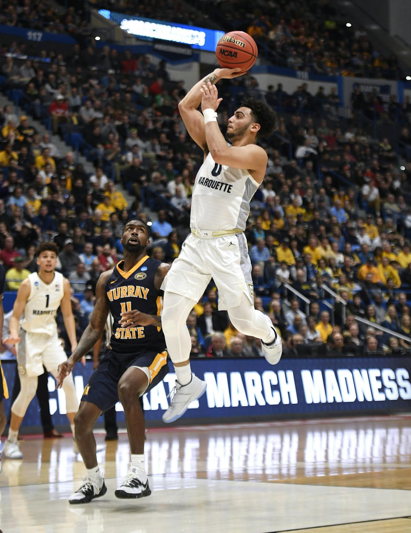 Marquette's Markus Howard (0) shoots over Murray State's Shaq Buchanan (11) during the first half of a first round men's college basketball game in the NCAA tournament, Thursday, March 21, 2019, in Hartford, Conn. (AP Photo/Jessica Hill) ORG XMIT: CTJH119