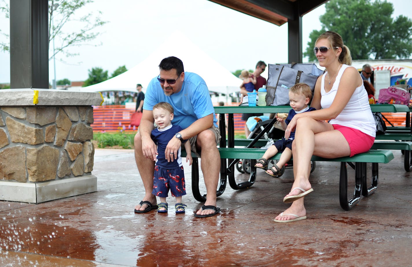 Rosemount residents Tim and Nichole Hall and their 20-month-old twin sons, Greyson (left) and Henry, sat in the new picnic shelter area adjacent to the splash pad, watching the weekend crowd.
Photo by Liz Rolfsmeier, Special to the Star Tribune