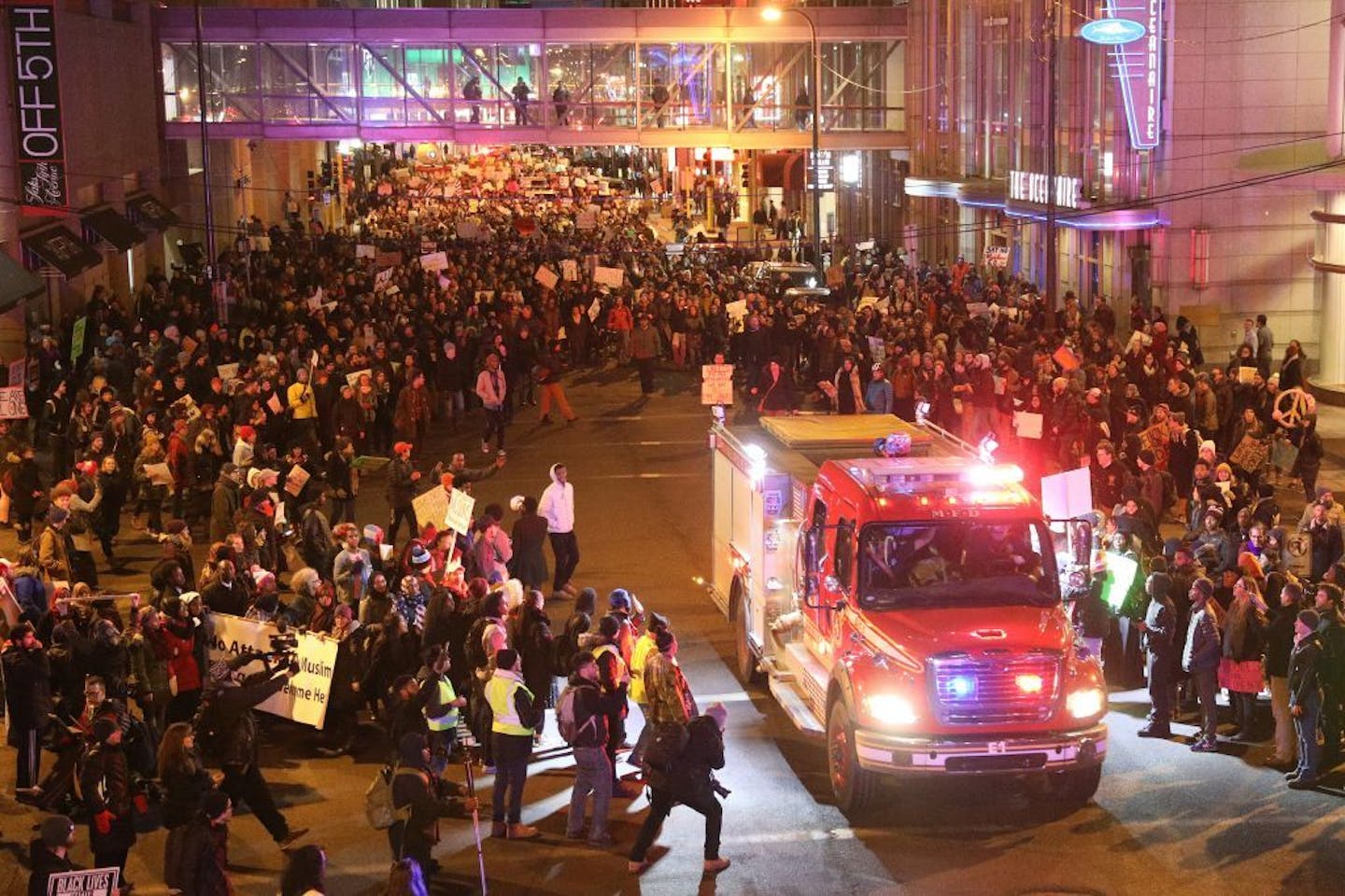 Protesters cleared a way for an emergency vehicle as they marched against President Trump's temporary immigration ban on seven predominantly Muslim countries Tuesday.