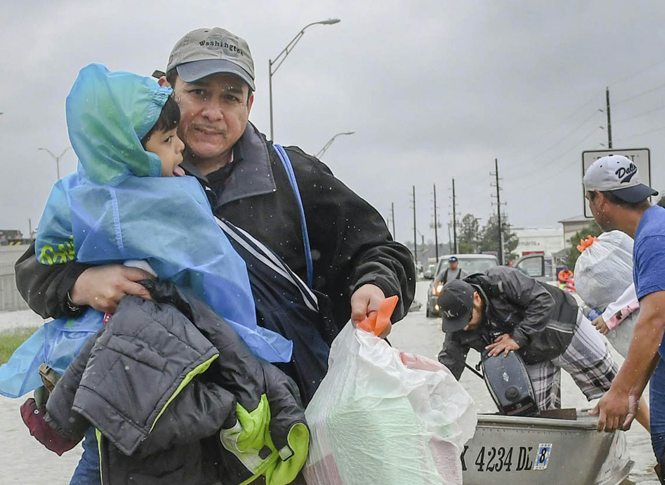 Volunteers and first responders work together to rescue residents from rising flood waters in Houston, Tuesday, Aug. 29, 2017. (Scott Clause/The Daily Advertiser via AP) ORG XMIT: MIN2017083012234841