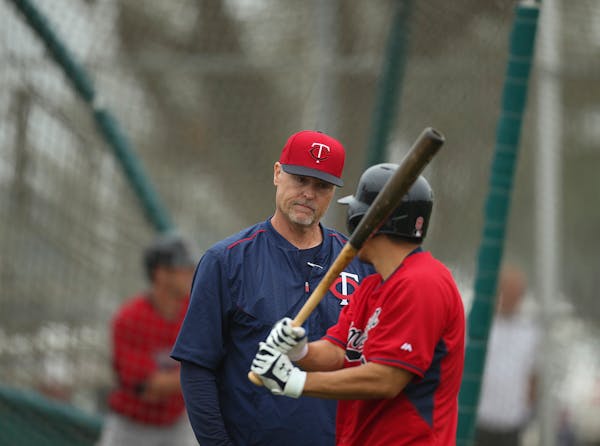 Hitting coach Tom Brunansky talked with catcher Kurt Suzuki during batting practice in spring training.