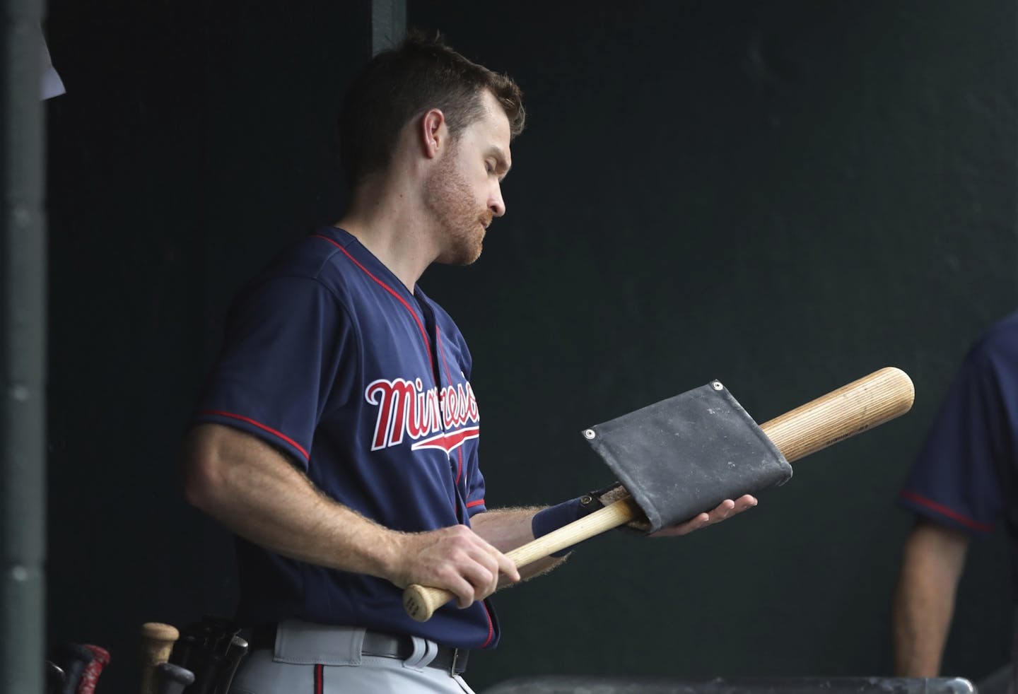 Minnesota Twins' Logan Forsythe pine tars his bat during the first inning of a baseball game against the Detroit Tigers, Saturday, Aug. 11, 2018, in Detroit.