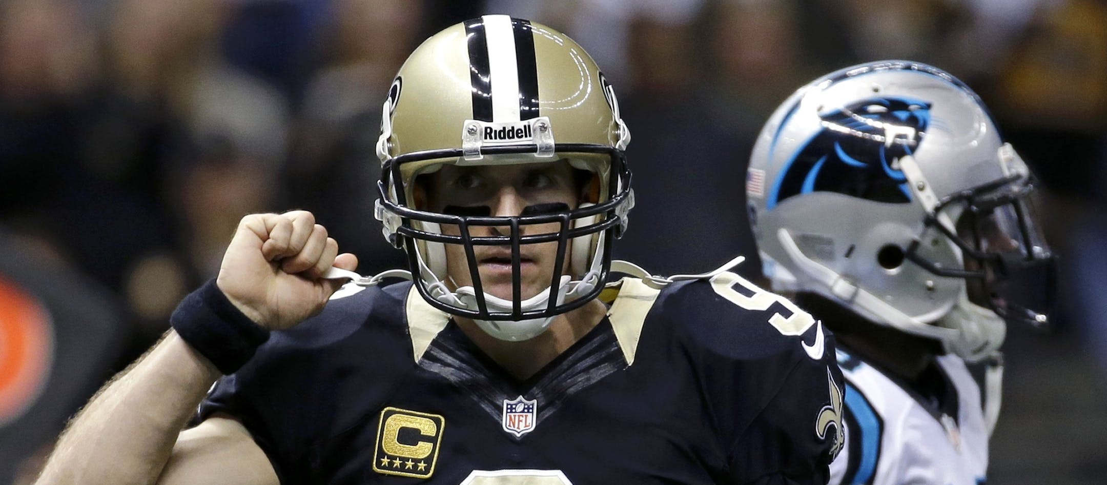 New Orleans Saints quarterback Drew Brees (9) reacts after a touchdown pass in the first half of an NFL football game against the Carolina Panthers in New Orleans, Sunday, Dec. 8, 2013. (AP Photo/Dave Martin)