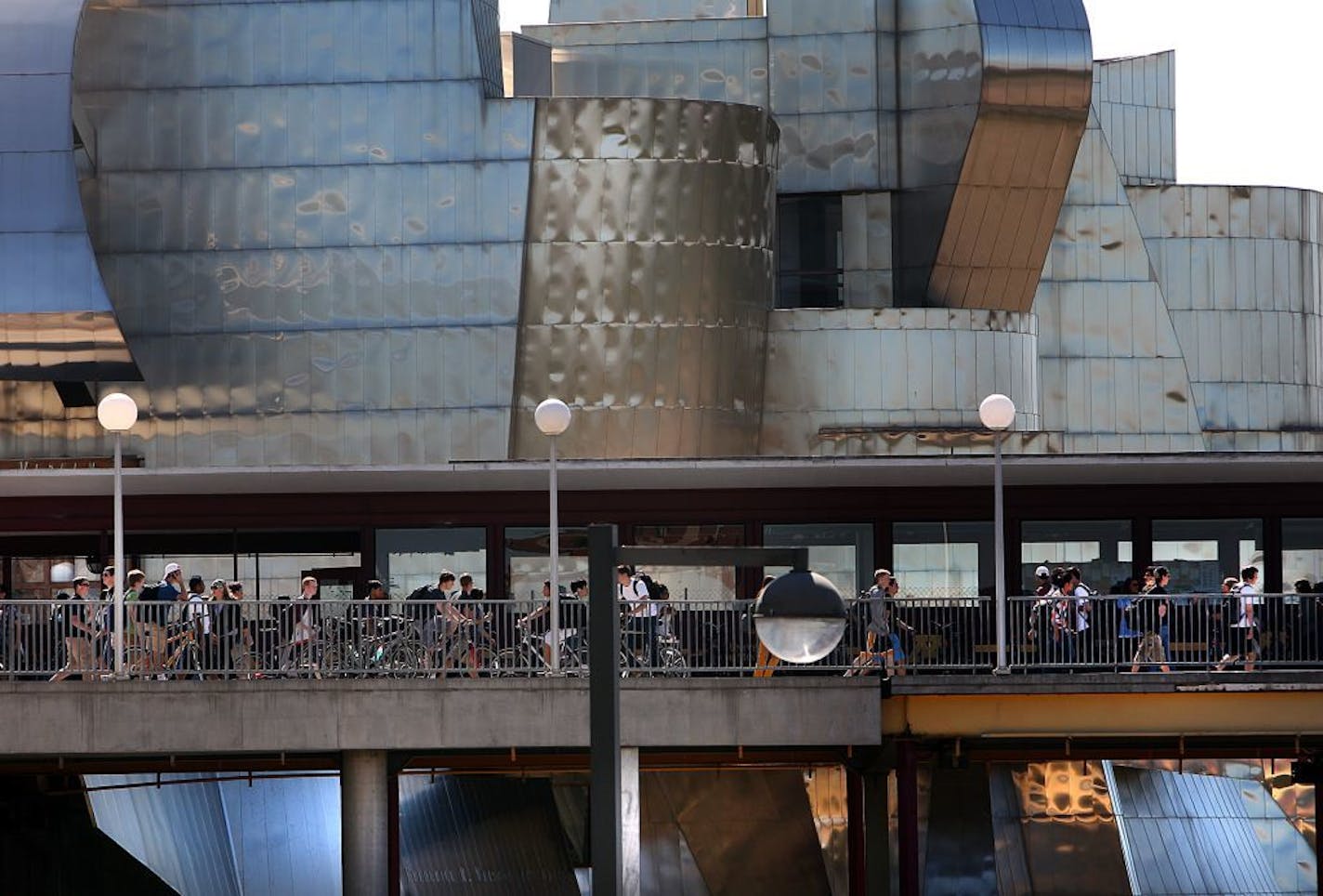 Students walked along the Washington Ave. Bridge, in the shadow of the landmark, Frederick R. Weisman Art Museum, with its distinctive, stainless steel facade. The building overlooks the University of Minnesota campus and the Mississippi River. Completed in 1993, the building has undergone expansion over the past year that includes several new galleries.