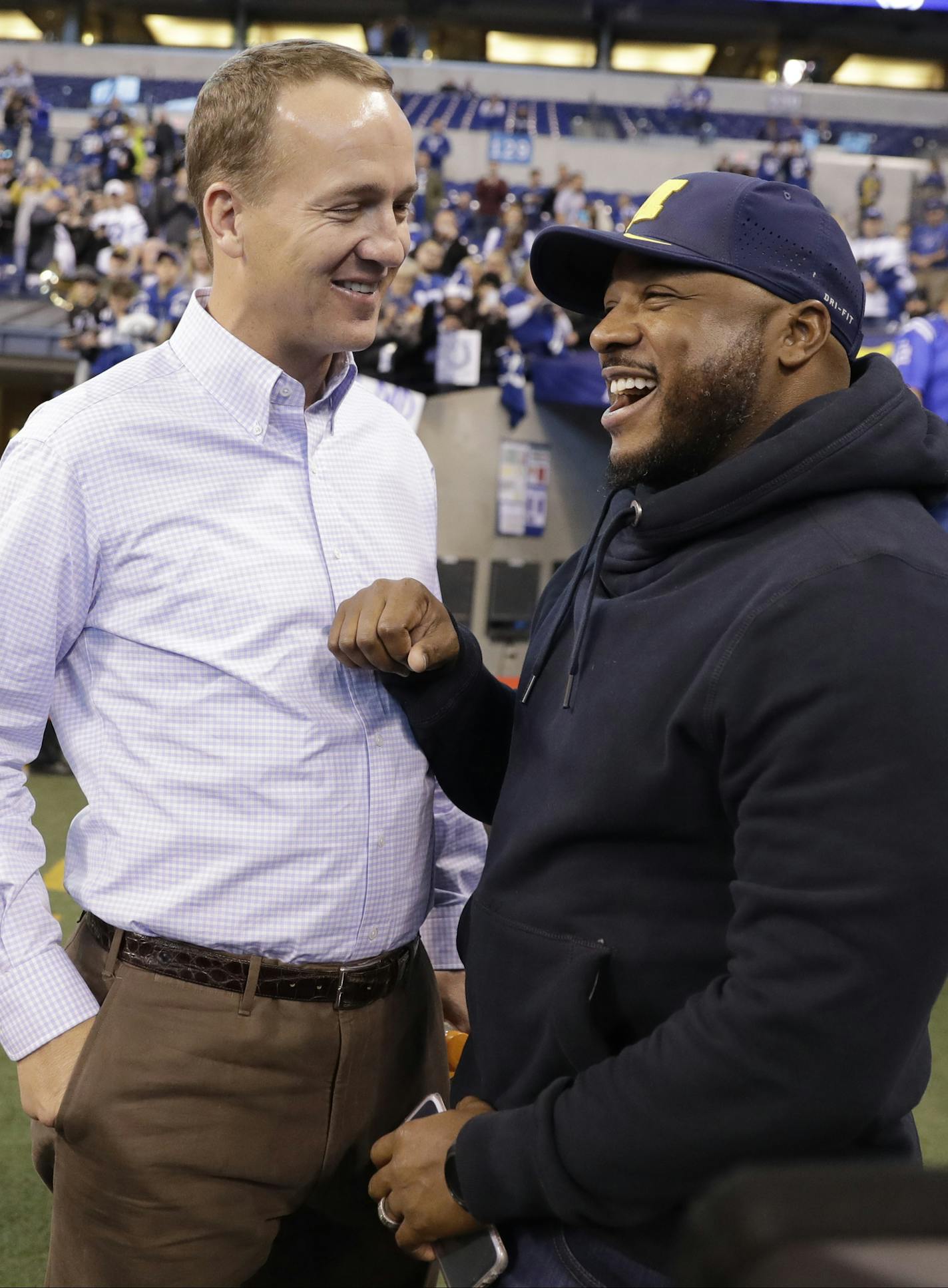 Former Indianapolis Colts players Peyton Manning, left, and Cato June chat before an NFL football game between the Tennessee Titans and the Indianapolis Colts in Indianapolis, Sunday, Nov. 20, 2016. (AP Photo/Darron Cummings) ORG XMIT: INMC1