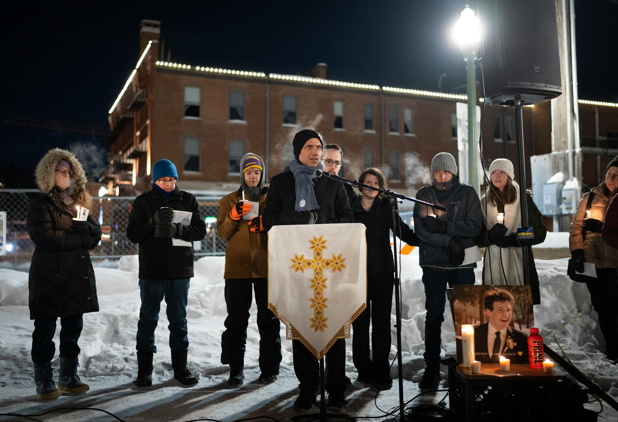 Fr. Michael Izen addressed the crowd and led them in a prayer. A vigil was held Monday night, December 26, 2022 on the plaza next to the lift bridge in Stillwater.