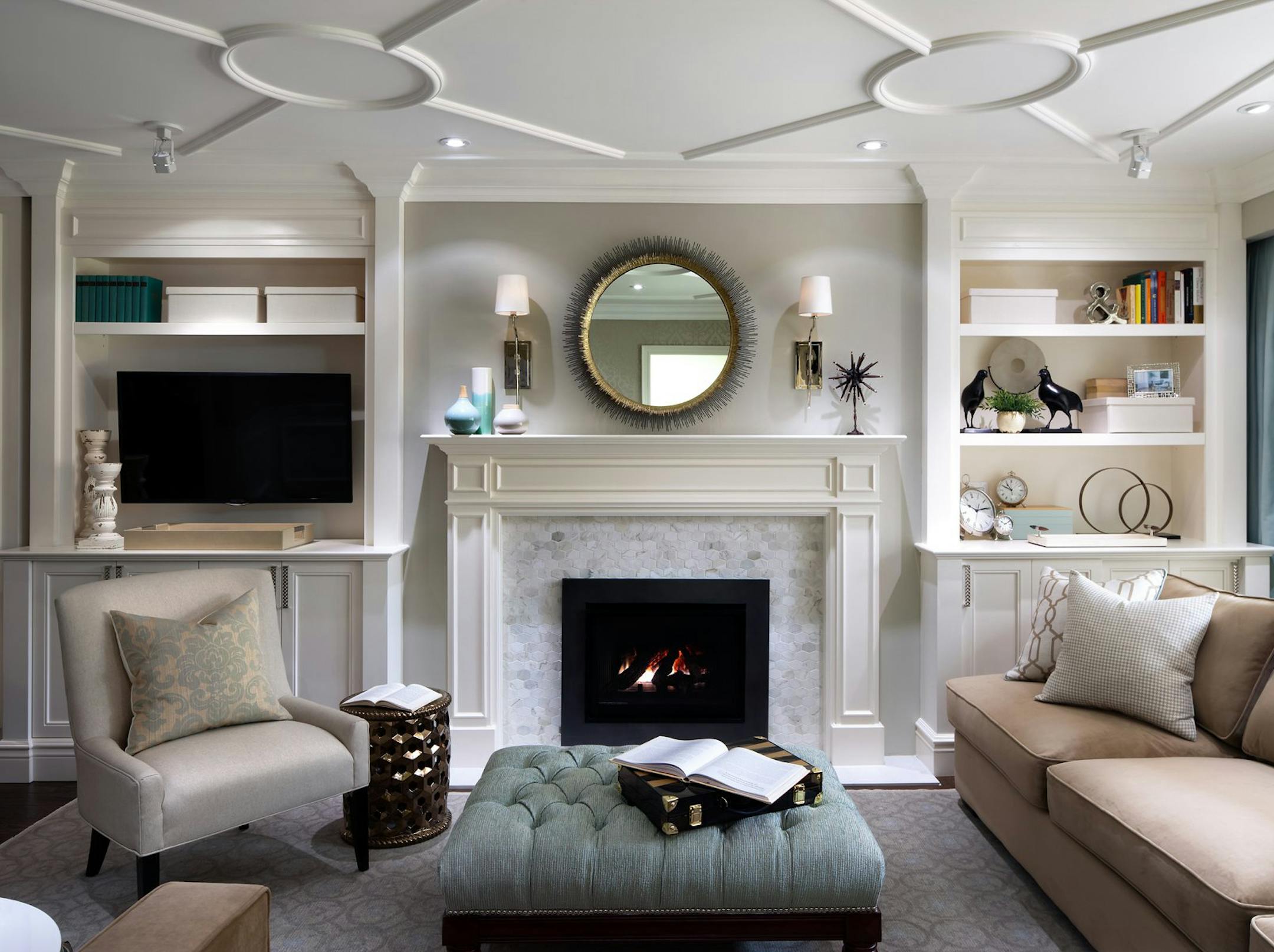 Over in the living room, a new gas fireplace insert was surrounded with polished marble. Above the fireplace, we hung a round mirror and flanked it with two sconces. On either side of the fireplace there's built-in cabinetry, creating storage and display space on one side, and a media center on the other. (Brandon Barre/MCT) ORG XMIT: 1150194