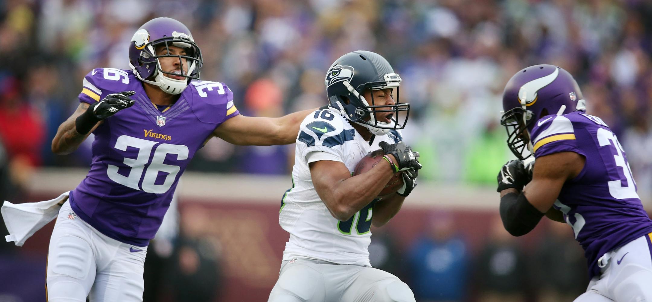 Seattle Seahawks wide receiver Tyler Lockett (16) picked up a first down as Minnesota Vikings strong safety Robert Blanton (36) reached for him, cornerback Antone Exum (32) was called for unnecessary roughness on the play Sunday December 6, 2015 in Minneapolis, MN.