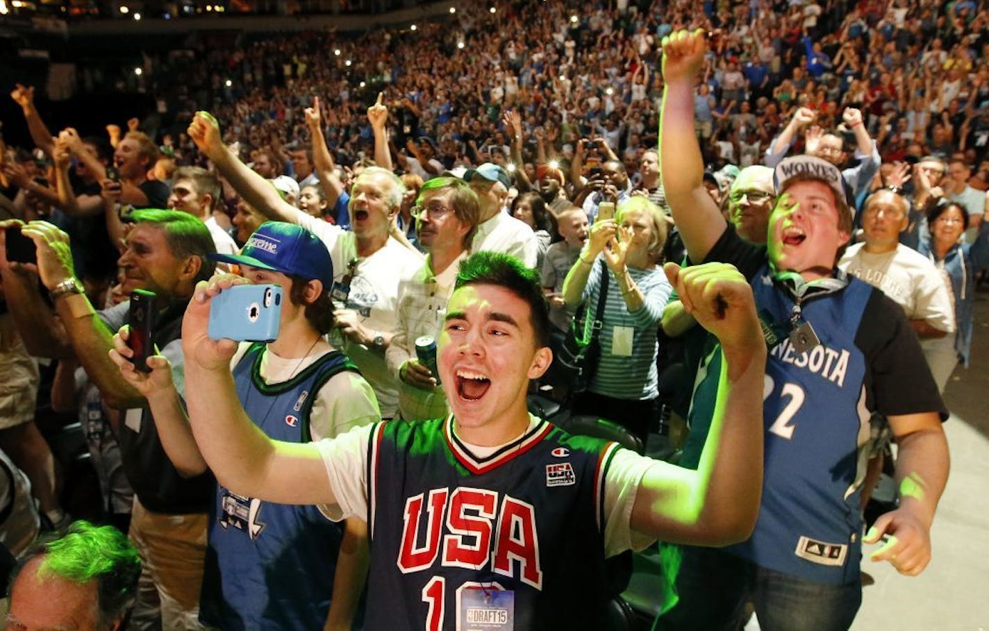 Minnesota Timberwolves fans Jordan Hennessey, 16, Jack Hennessey (middle) and Jeff Johnson (right) cheered after the Timberwolves selected Karl-Anthony Towns with the first pick of the 2015 NBA draft.