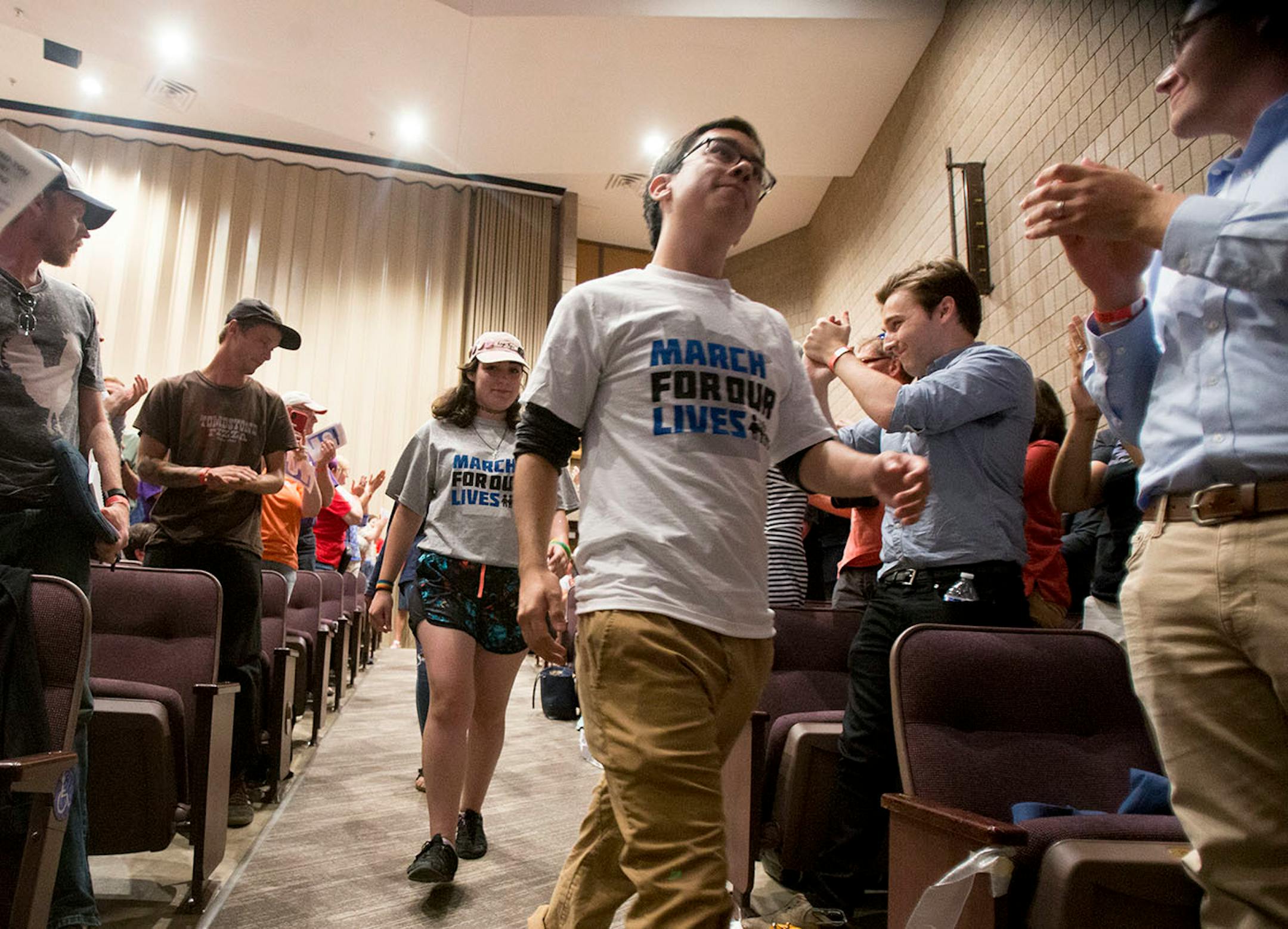 Jorge Esparza Hernandez, a student at Henry Sibley High School in Mendota Heights, MN, walks toward the stage to participate in the panel.